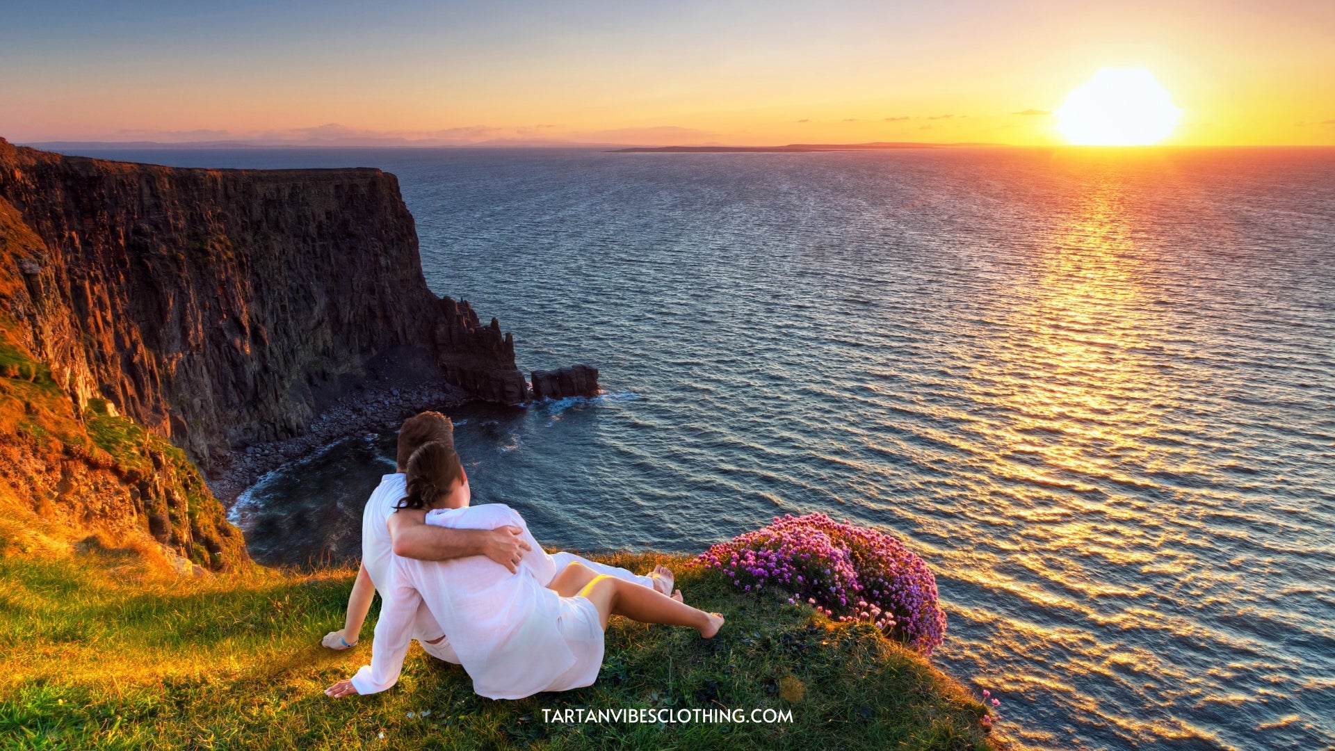 Couple in hug watching sunset on the edge of the cliff - IRISH VALENTINE'S DAY IDEAS WITH A TOUCH OF TRADITION