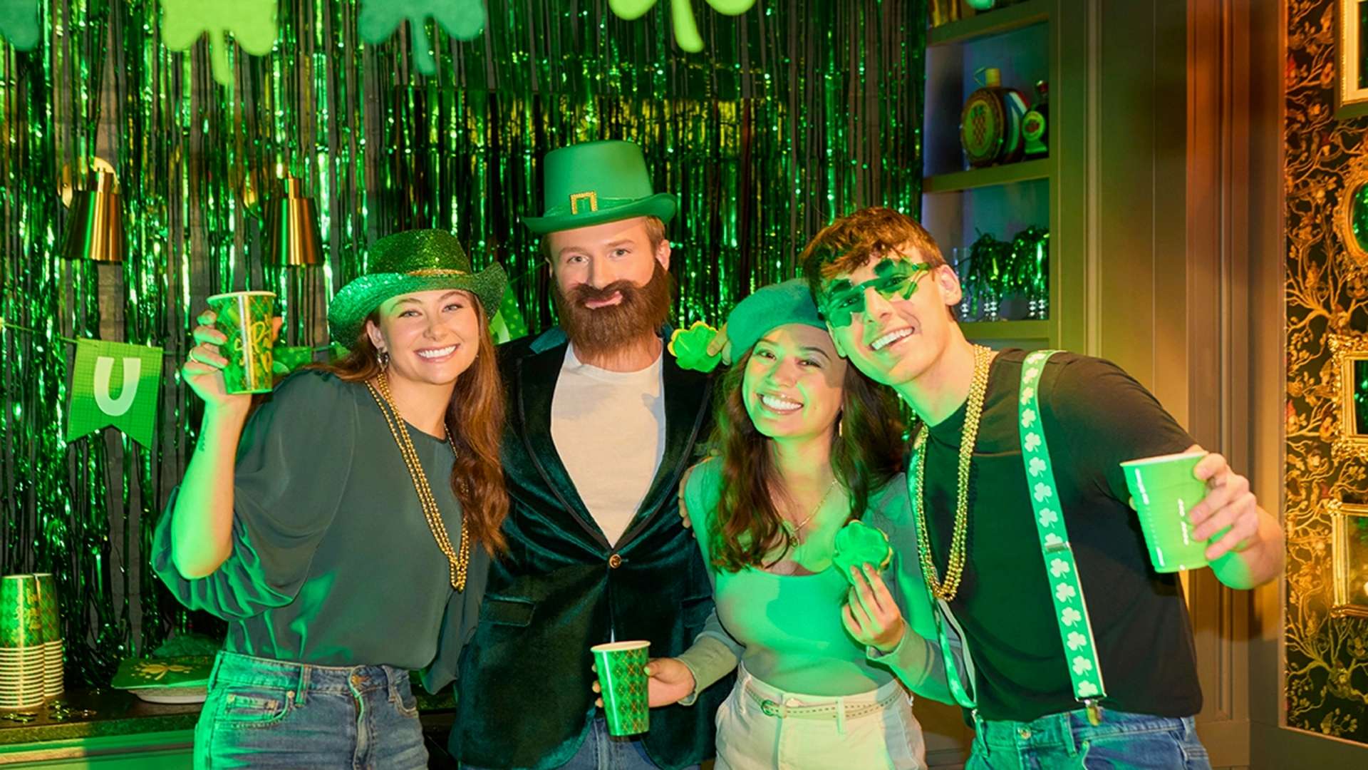 Friends dressed in leprechaun-themed outfits posing at a festive party.