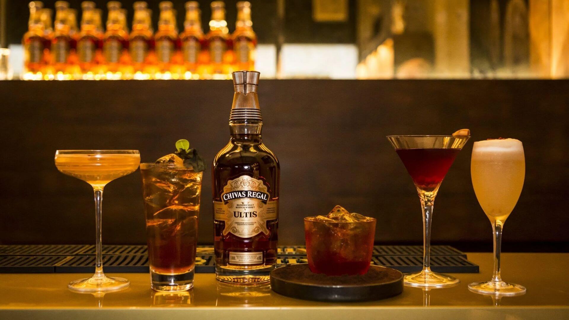Chivas Regal Ultis blended Scotch whisky bottle with elegant whisky cocktails displayed at bar