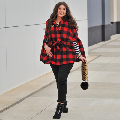 Woman wearing a Buffalo Check plaid cape in a bold casual style