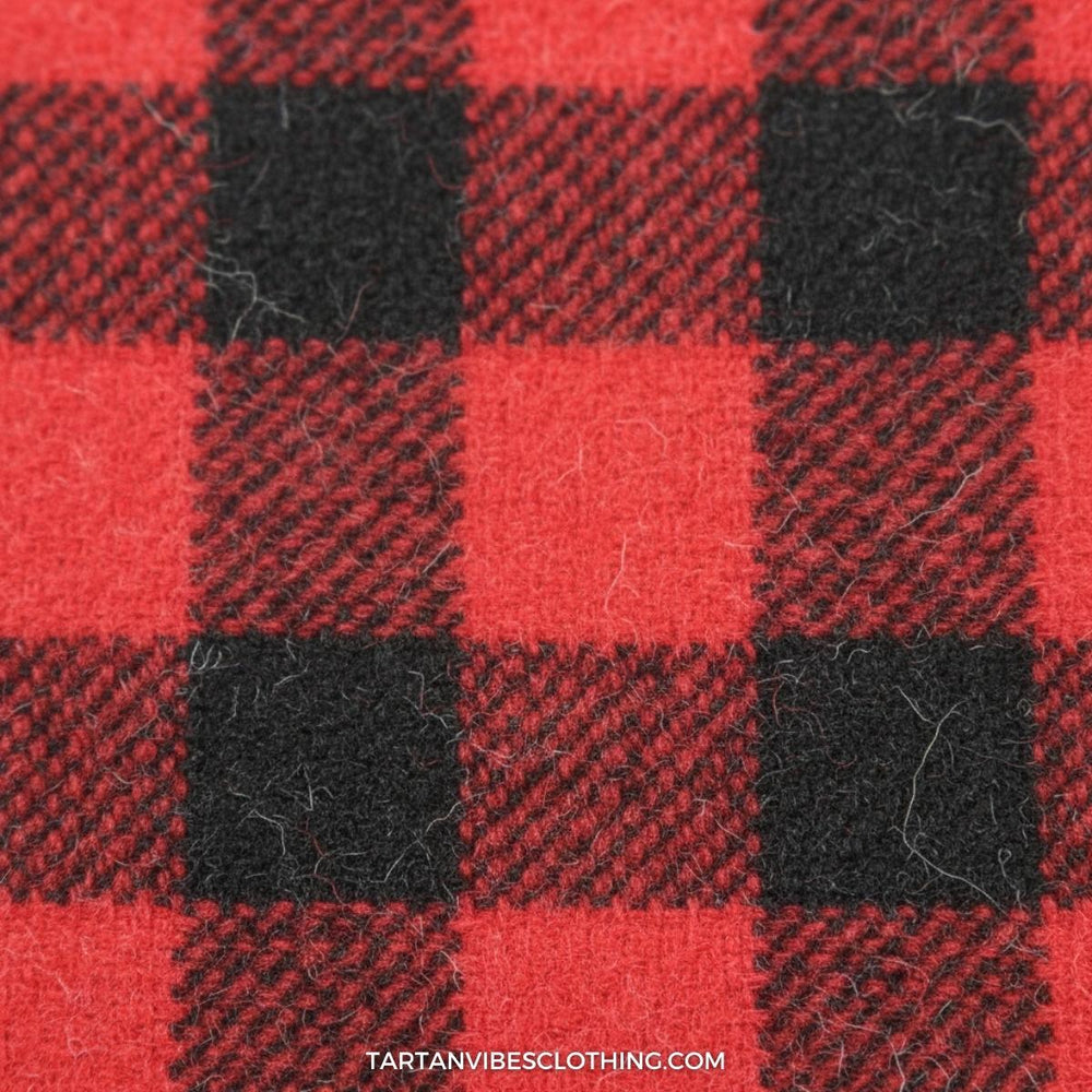 Close-up of red and black plaid flannel showing twill weave detail and the soft, brushed texture of traditional flannel fabric.