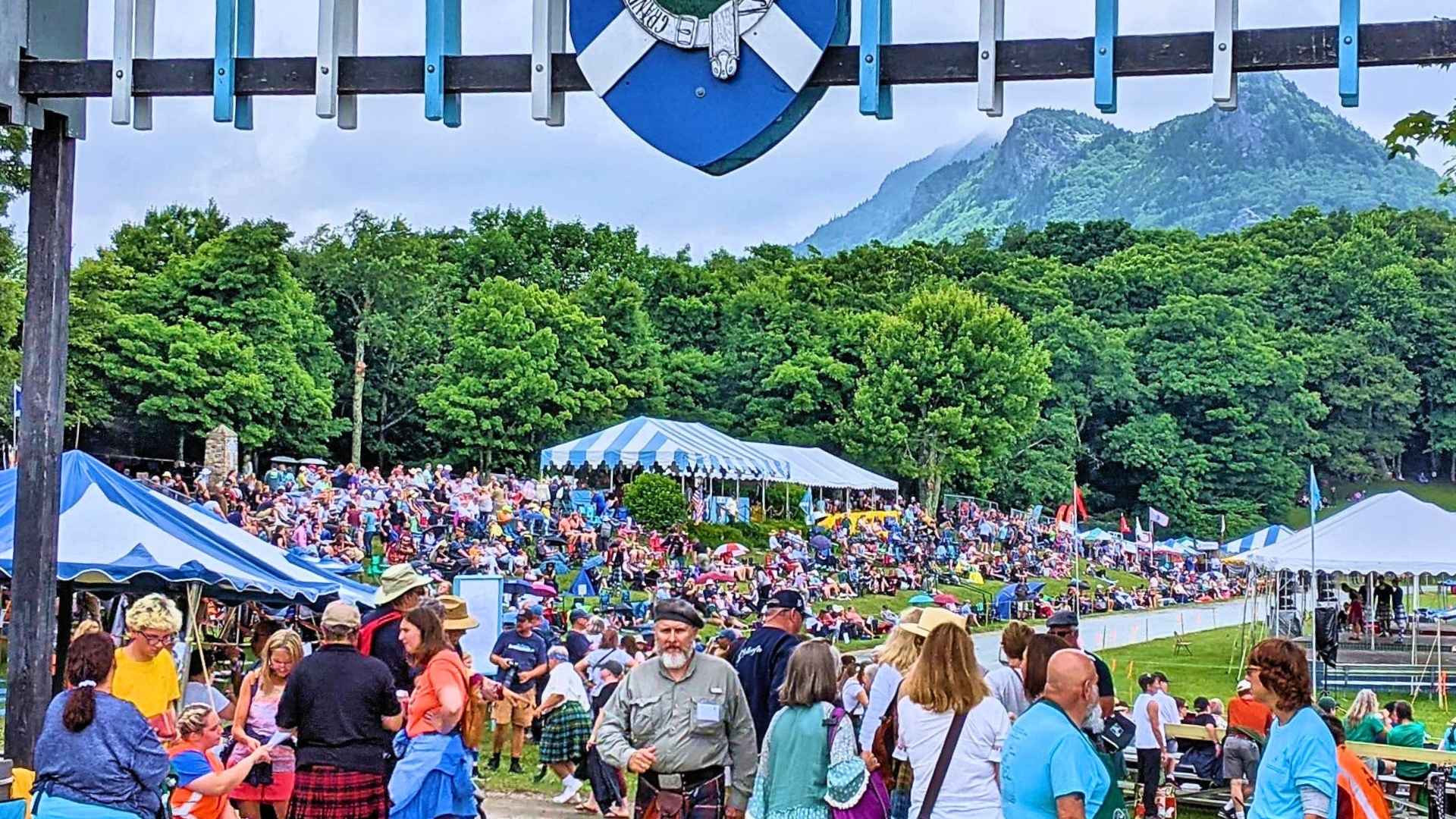 Crowds gather at MacRae Meadows with Grandfather Mountain in the background during the Highland Games.