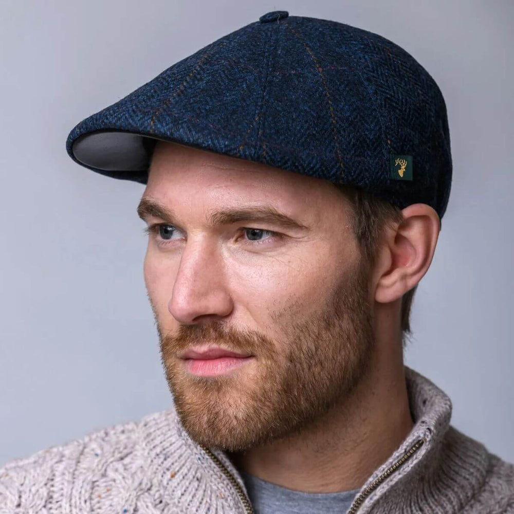 Man wearing a navy blue duckbill cap with textured fabric