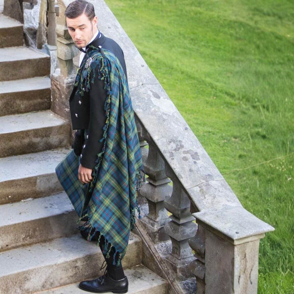 Man wearing a tartan fly plaid as part of formal Scottish Highland dress