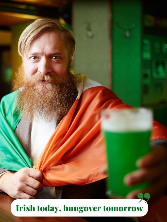 Bearded man in Irish flag with green beer for St. Patrick’s Day humor