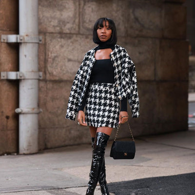 Woman wearing a Houndstooth coat styled with a modern monochrome outfit