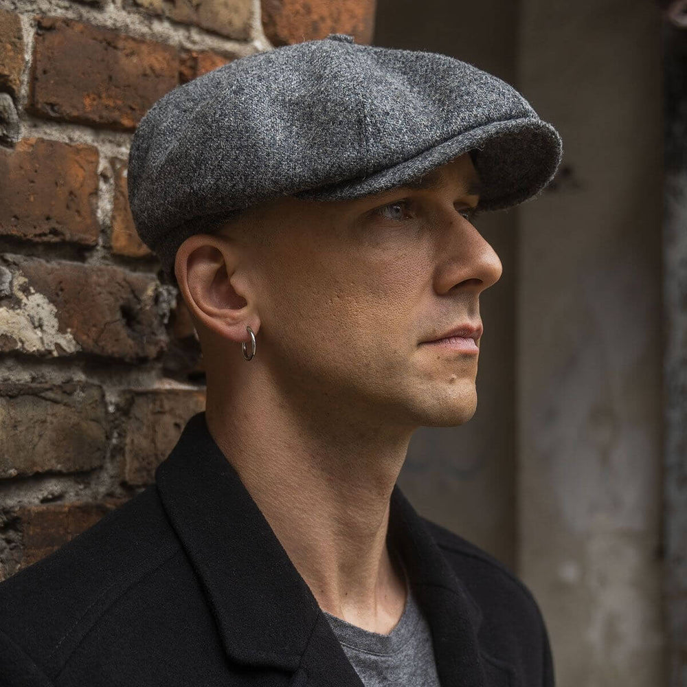 Man wearing a grey wool Shelby cap inspired by vintage Peaky Blinders style