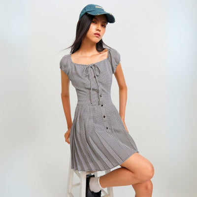 Woman wearing a Shepherd's Check dress with a classic monochrome pattern