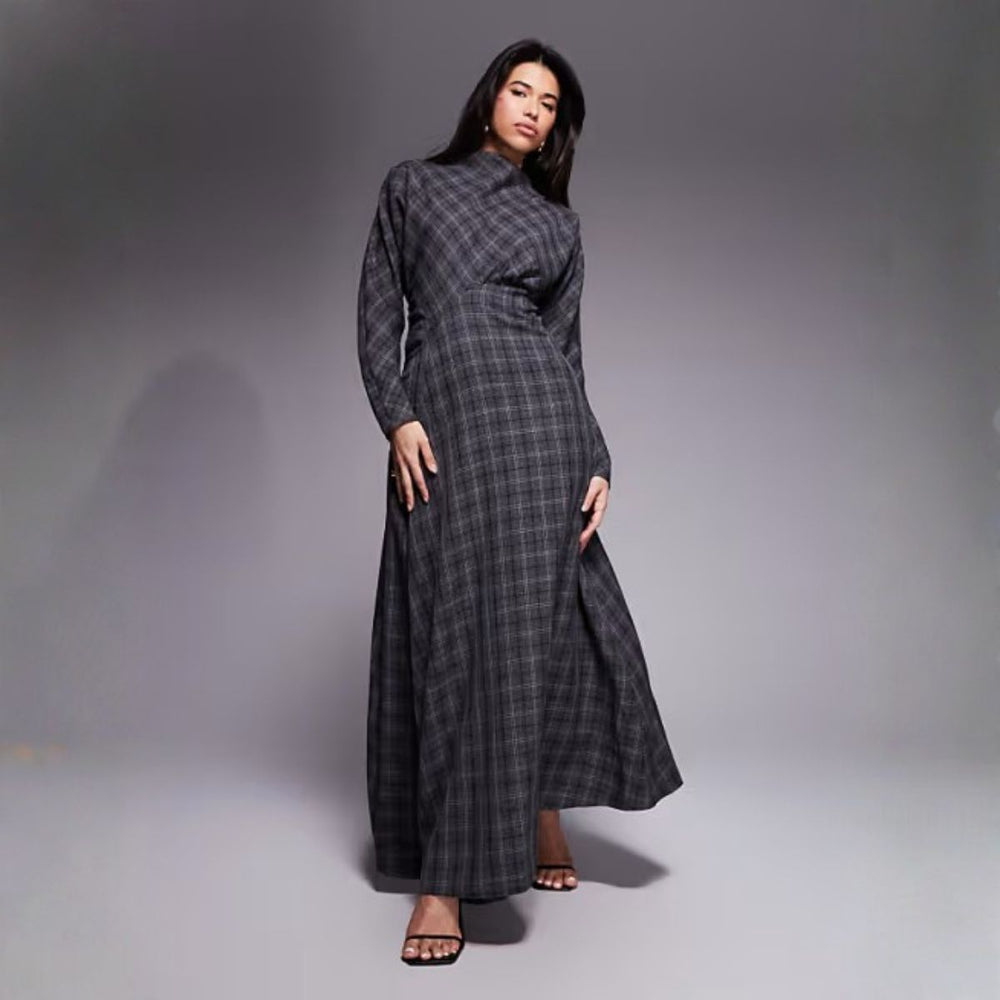 Woman wearing a long tartan high-neck dress with a modern elegant silhouette