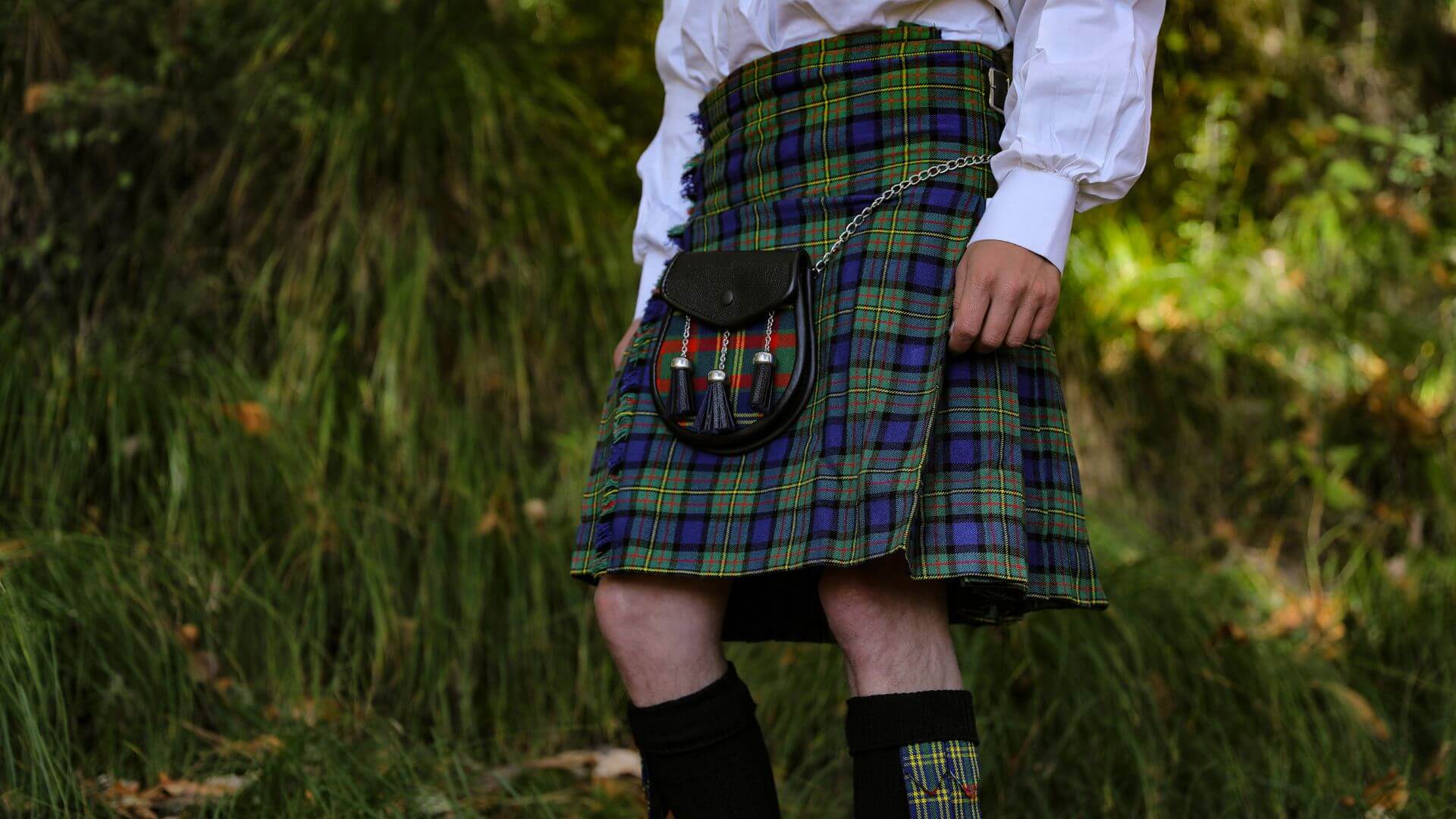 Scottish tartan kilt with sporran traditional Highland outfit showing clan pattern details