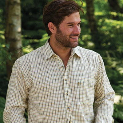 Man wearing a Tattersall check shirt with a timeless country-inspired style