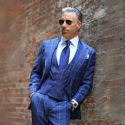 Man wearing a blue Windowpane plaid suit with a modern tailored fit