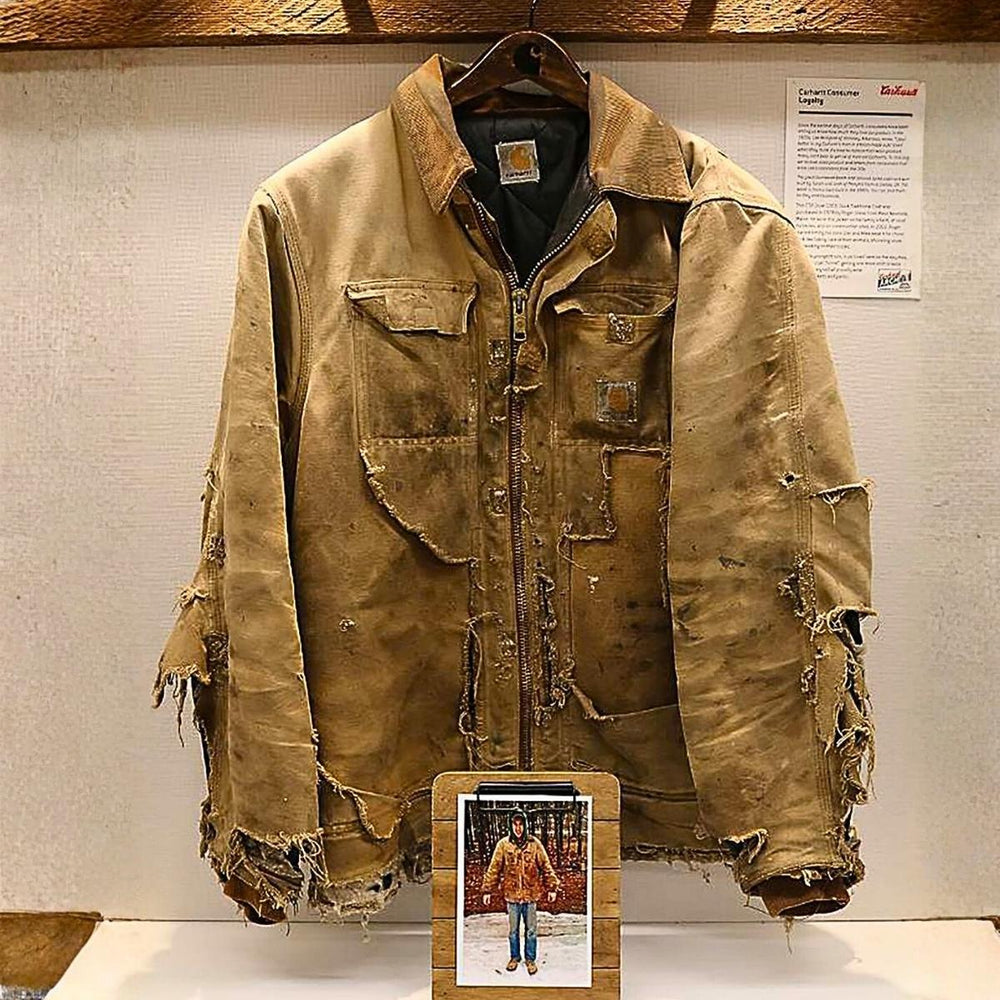 Worn Carhartt work jacket showing rugged, durable construction, illustrating early American workwear linked to flannel’s evolution.